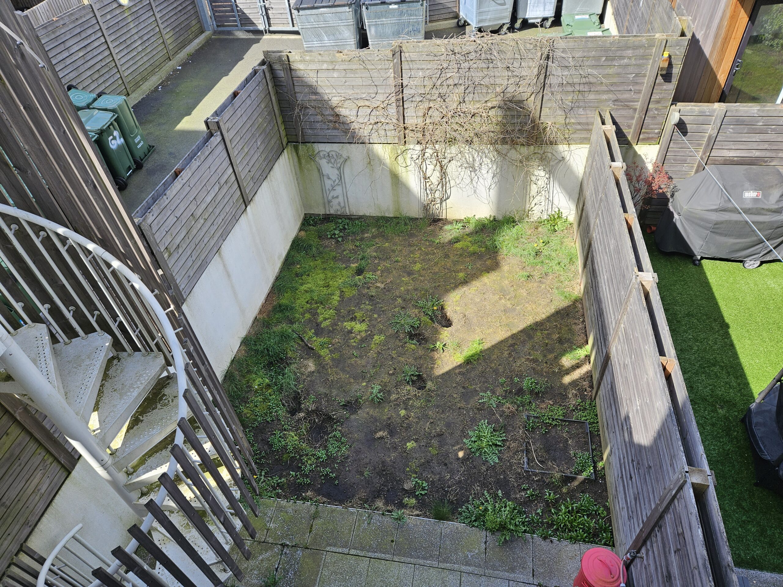 Small garden transformation in St Albans before landscaping transformation with old paving and planting areas